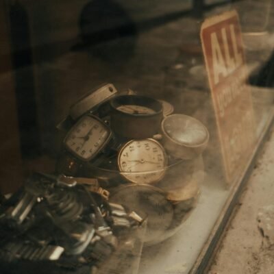 Discover a collection of vintage watches in an antique store window, evoking a retro feel.